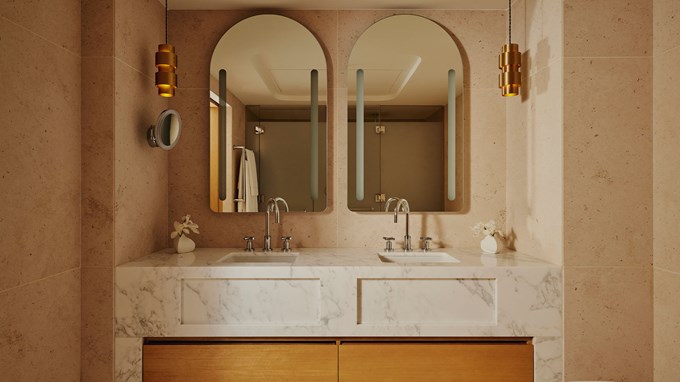 Double marble sink in bathroom, with silver taps and circular mirrors above.