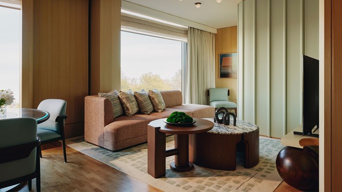 The Emory Park Suite living room area: coffee table, sofa with cushions, beige coloured rug.